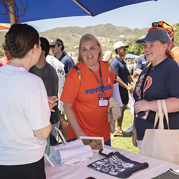 people talking at a booth