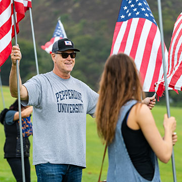 two people holding American flags