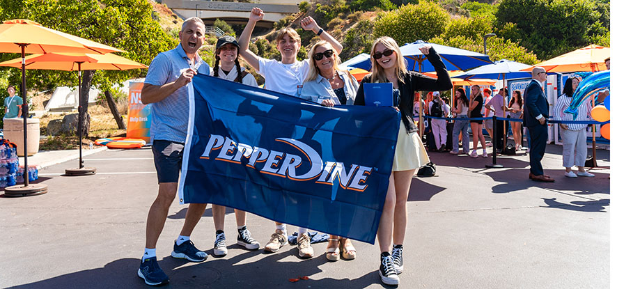 parents and students holding a Pepperdine banner