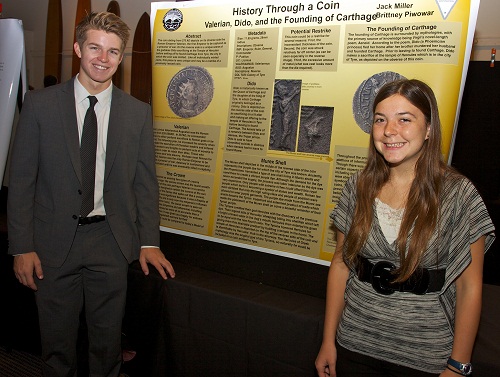 Jack Miller and Brittany Piwowar next to their poster.