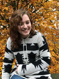 Bonnie Graham pictured in front of a tree with yellow leaves