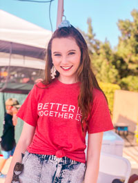 Erin Miller pictured in a red t-shirt that reads Better Together