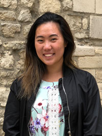 Kim Yeung pictured in front of a brick wall