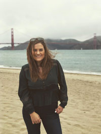 Morgan Nelson pictured on the beach in front of the Golden Gate Bridge