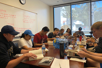 Students reading around a table