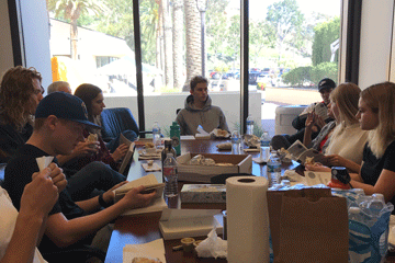 Students enjoying a meal while reading