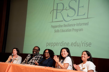 RISE staff sitting at a panel