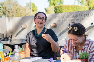 Staff and students painting pottery