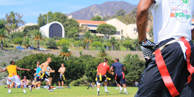 Students playing flag football in Alumni Park