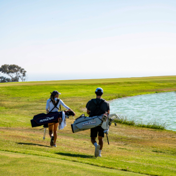 golf players walking on the golf course